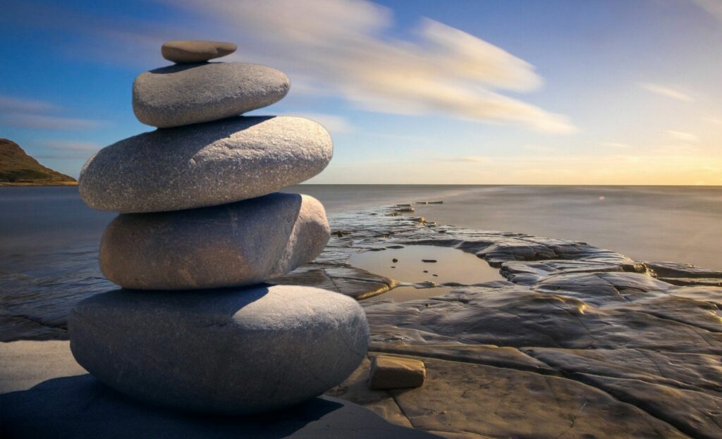 rocks balanced on beach