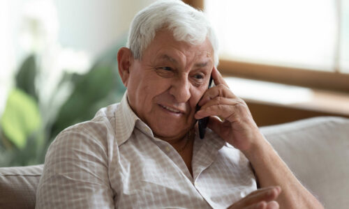 Smiling Older man talking on the phone